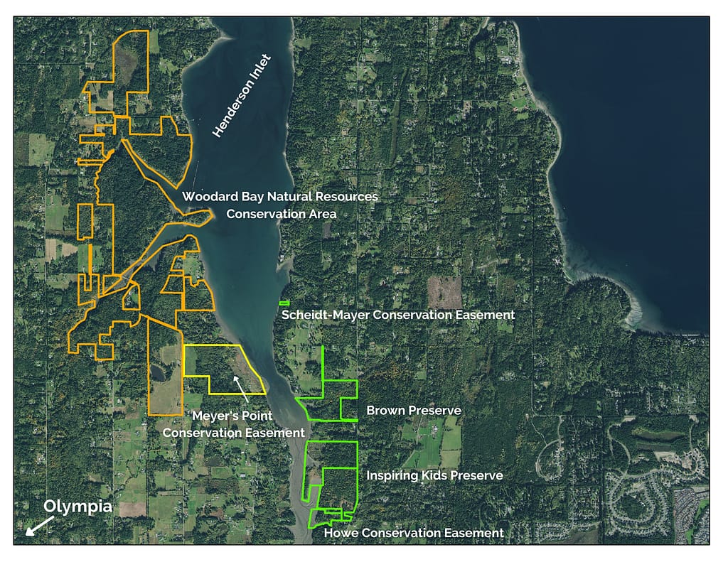 Areas of land outlined on a map. Meyer's Point is outlined in yellow to the south of Woodard Bay Conservation Area. Four other properties are outlined in green an represent other areas conserved by CLT.